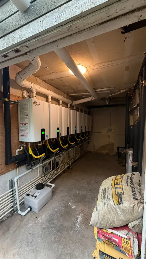 Wall-mounted tankless water heaters in a commercial service room